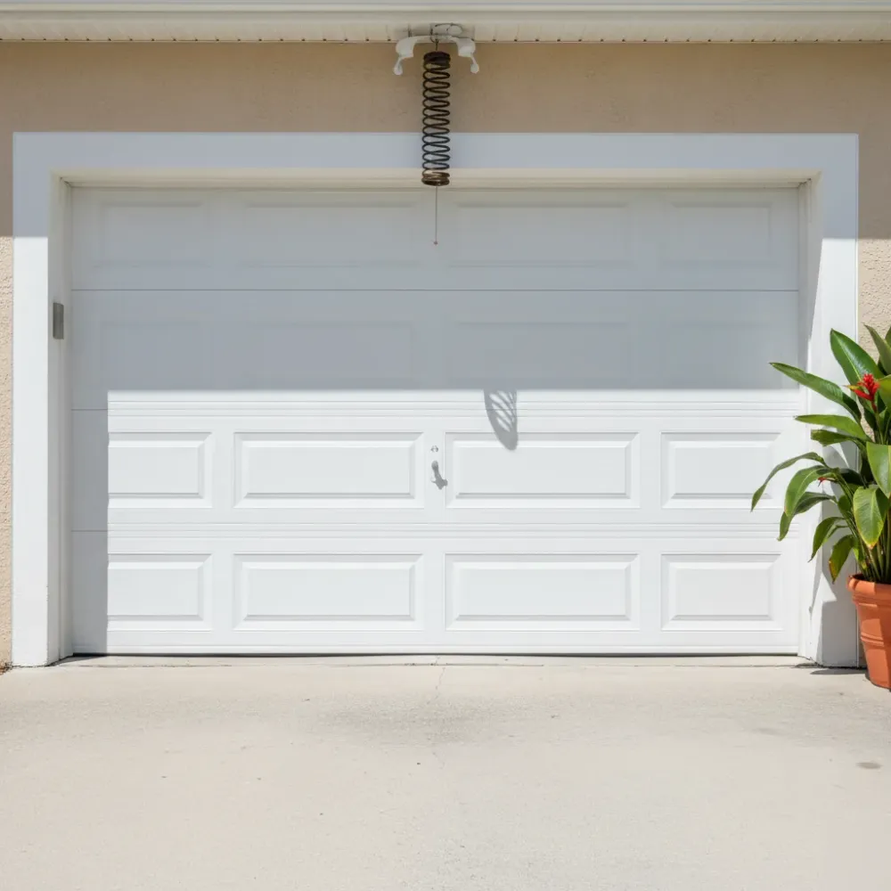 Fully closed white residential garage door with new rollers and aligned torsion spring after completed repair service.