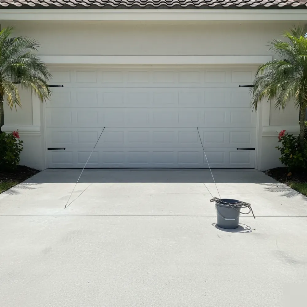 Residential garage door hanging level and closed after new steel lift cables were installed on both sides.