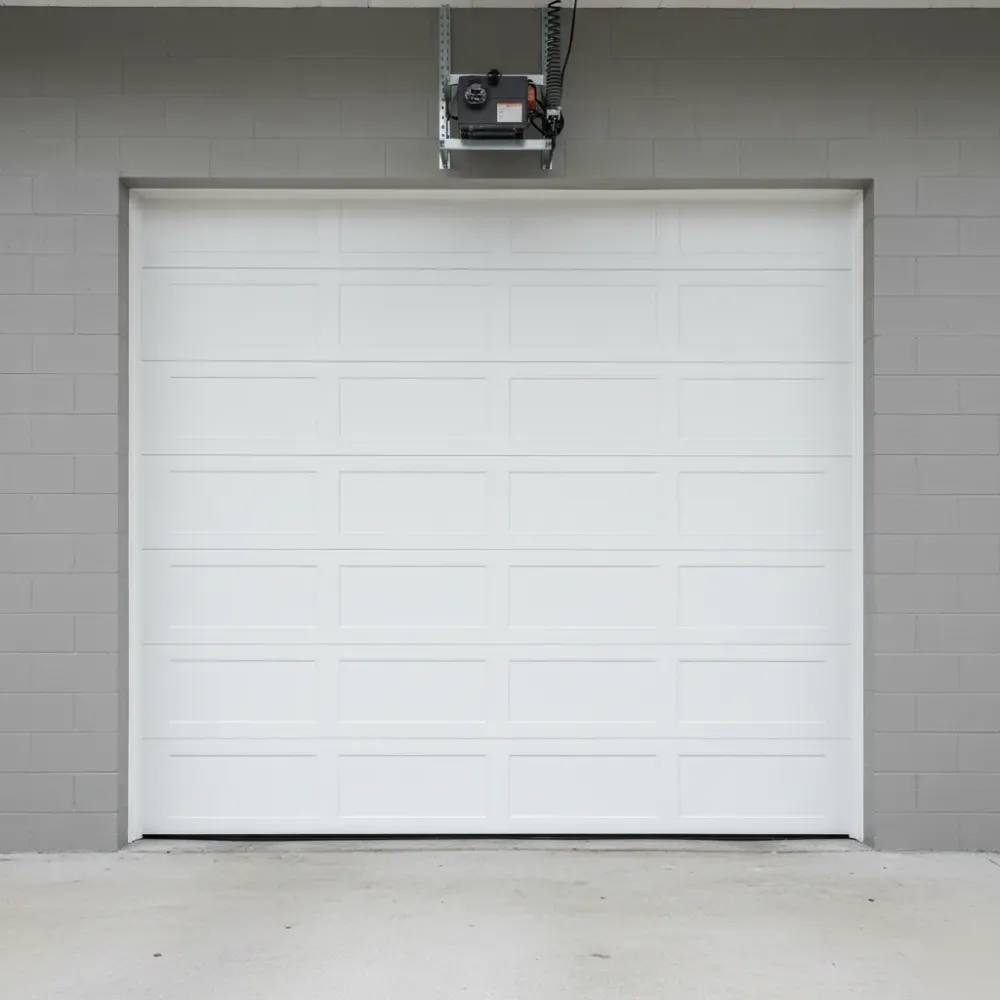 completed-commercial-garage-door-install-powder-coat-hallandale-beach Newly installed white powder-coated commercial garage door fully closed on a concrete block building in Hallandale Beach.