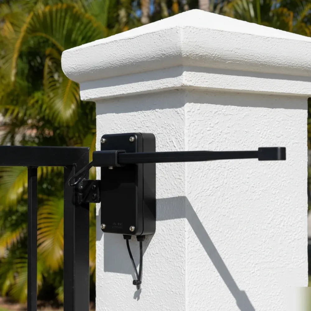 Repaired automatic gate opener mounted on a stucco pillar with new wiring and a secured control panel in Hallandale Beach.