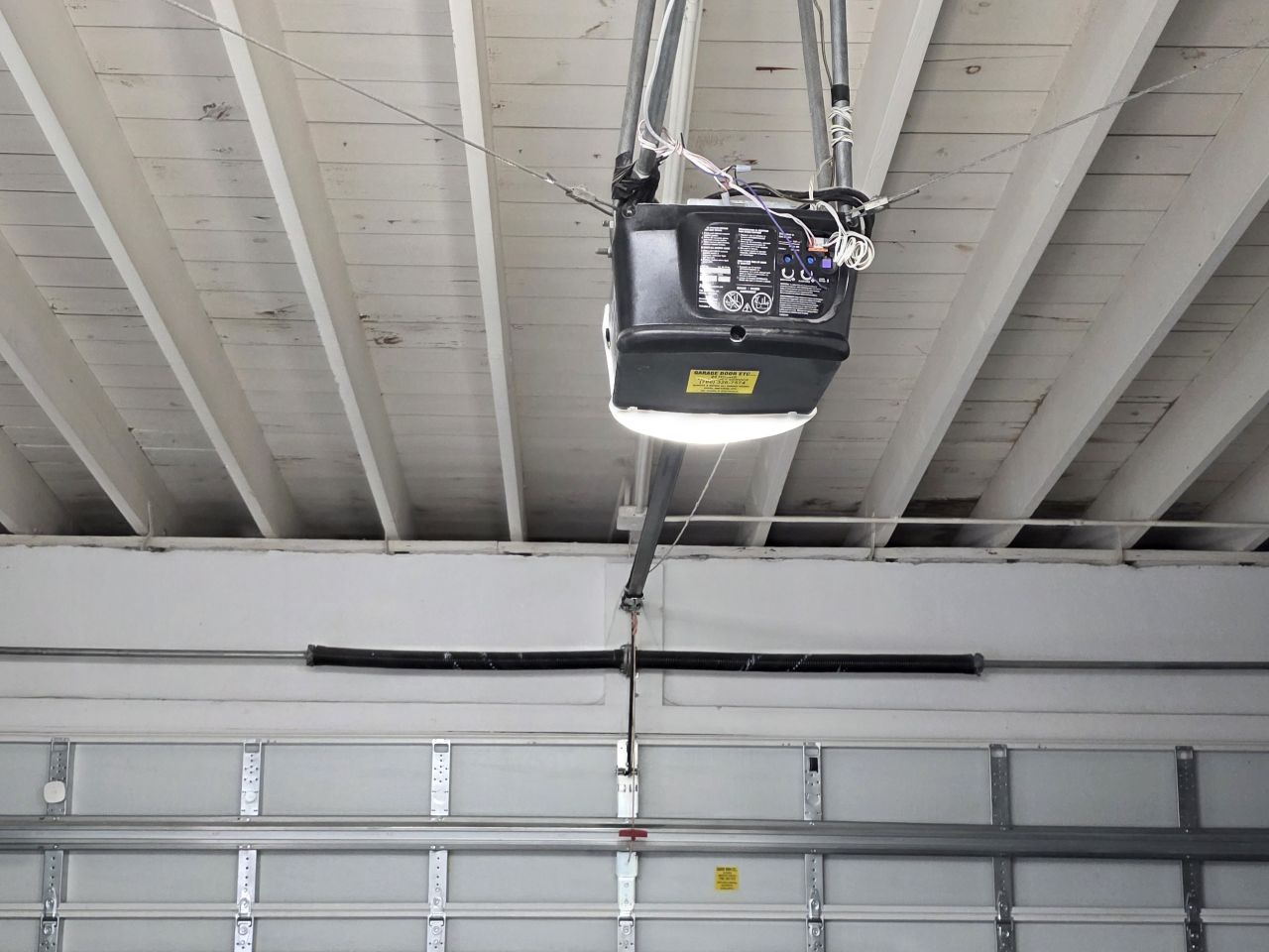 Repaired garage door opener system fully aligned in Hallandale Beach home garage
